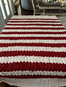 Red and white striped blanket on a table with a blurred background