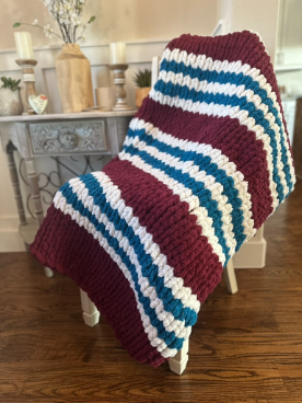 Striped blanket draped over a chair in a home setting
