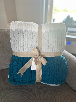 Knitted blanket with a bow on a couch in a bright room