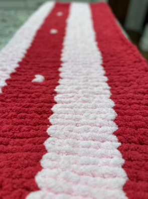 Close-up of a red and white striped knitted blanket.